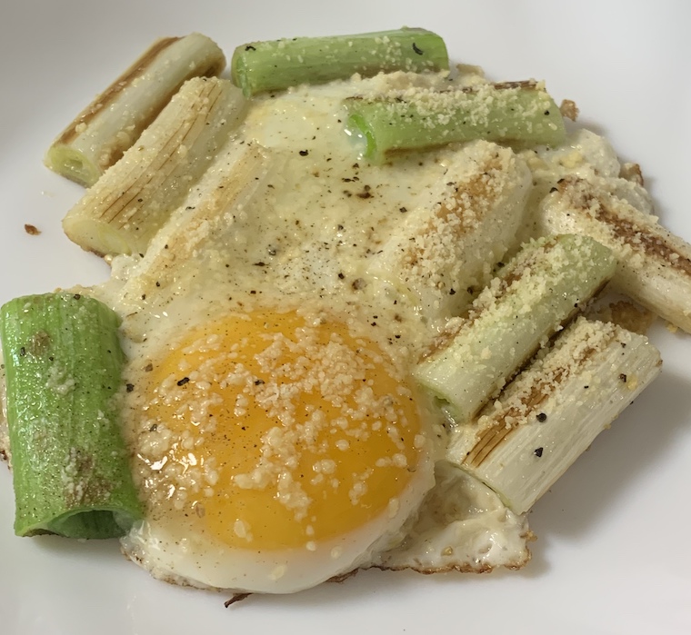 Grilled green onion with sunny side up egg on top