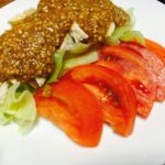 Bon bon chicken with sesame sauce and sliced tomatoes and lettuce on side