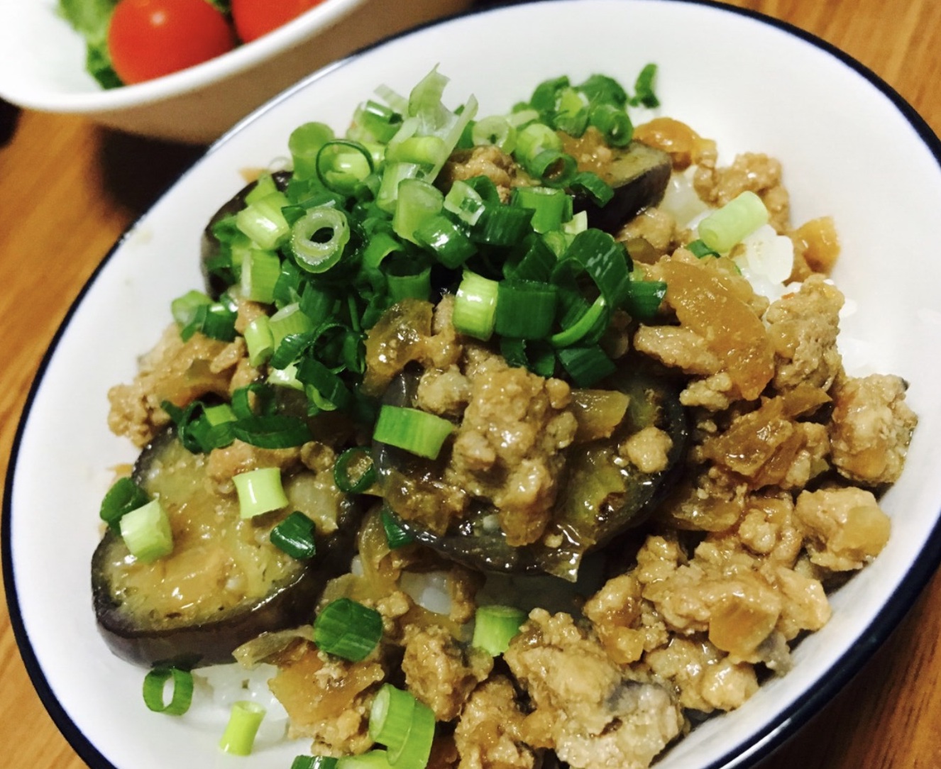 Miso stir-fry with eggplant and ground pork and sliced green onion on top.