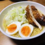 Chicken paitan ramen with roasted chicken, boiled eggs and green onions as toppings