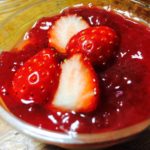 Milk pudding covered with strawberry sauce on top.