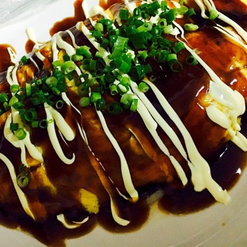 Okonomiyaki covered with sauce and mayo
