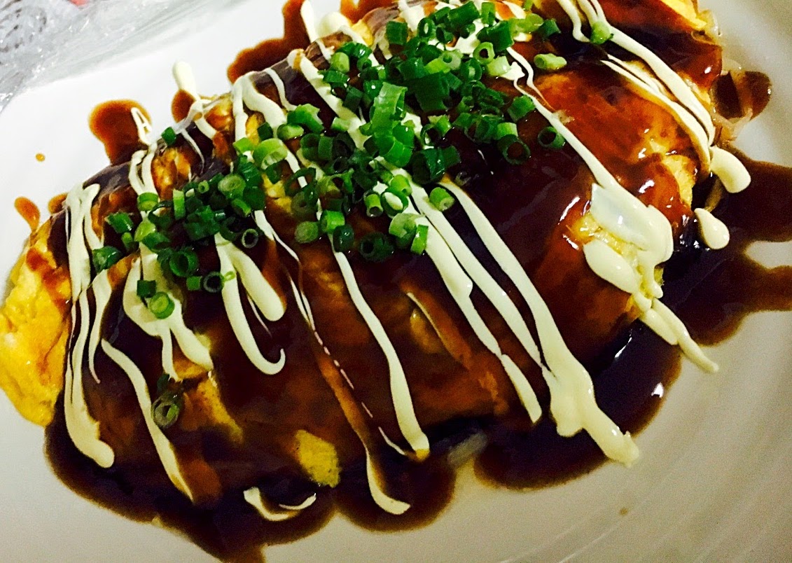 Okonomiyaki covered with sauce and mayo