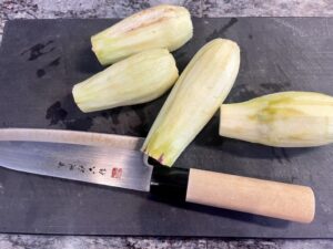 Peeled Eggplants with cooking knife